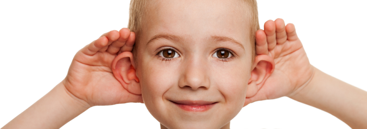 little boy with his hands on his ears