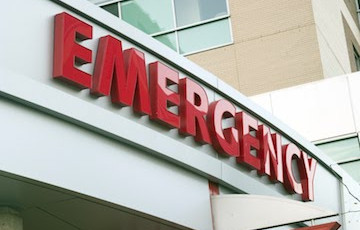 Large red letters that spell "Emergency" in front of an emergency department