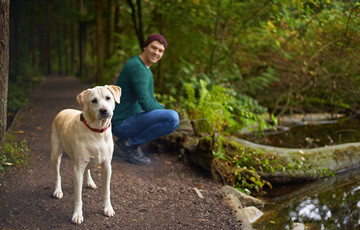 man with dog in forest