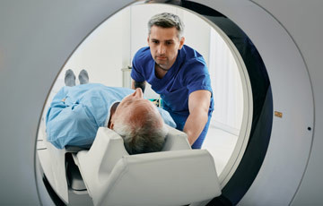 Photo of patient being assisted with scan