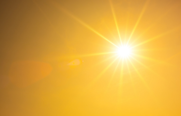 sun shining brightly in hazy sky