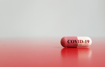 Medical pill with COVID-19 coronavirus on it