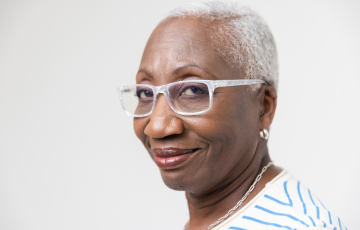 A senior woman wearing glasses