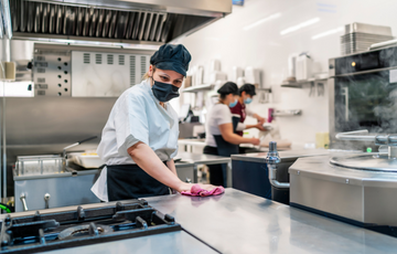 Chef cleaning a kitchen