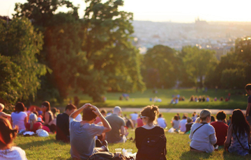 multiple people sitting in a park garden