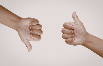 a picture of two hands one with thumbs up one showing thumb down