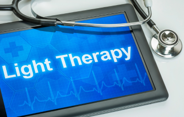 tablet screen that displays the words "light therapy"