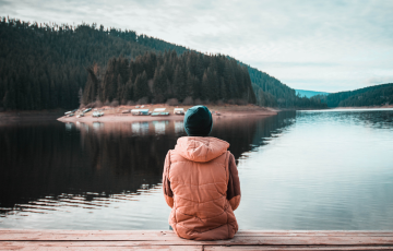 person sitting by the water