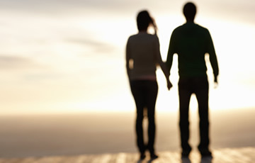 silhouette of couple holding hands 
