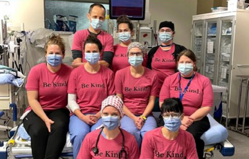 Nurses wearing masks and pink shirts that say be kind