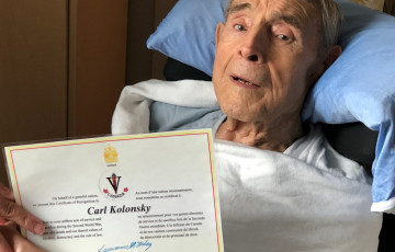 Carl with certificate of recognition for D-Day