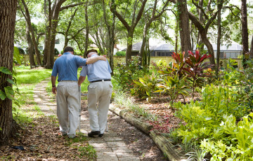 two men walking on a path 