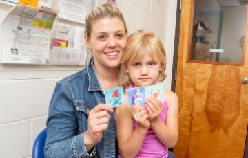 Mother and daughter smiling after immunization