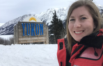 Field epidemiologist Courtney Rady Smith in front of Yukon sign