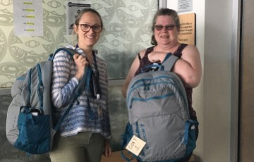 Two nurses holding backpacks