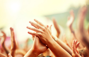 Hands clapping in festival crowd