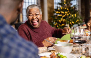 people laughing at the dinner table