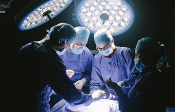 3 people performing a surgery