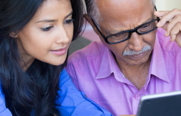 two people looking at a tablet screen